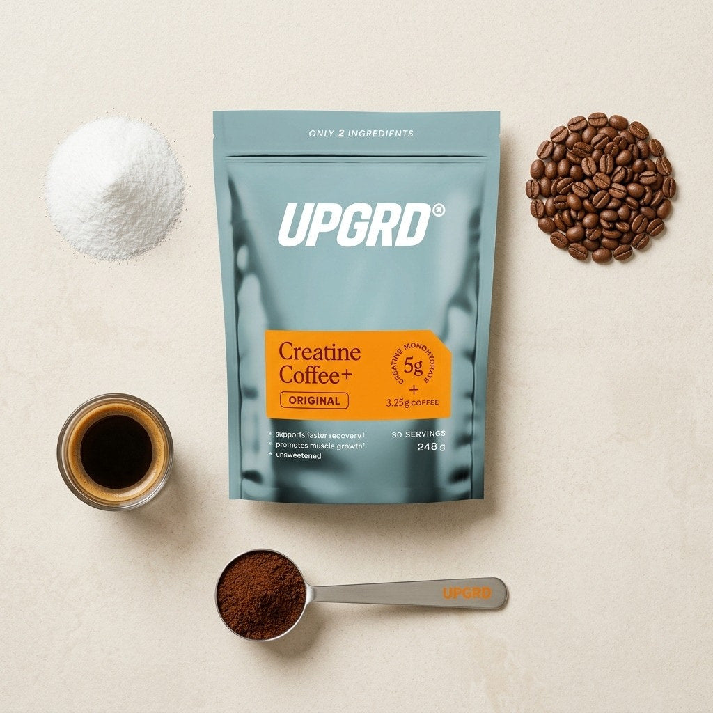UPGRD pouch laid out with creatine powder, coffee beans, ground coffee and a scoop