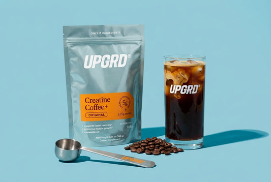 UPGRD Creatine Coffee+ Original pouch with a glass of iced coffee, coffee beans and a steel scoop